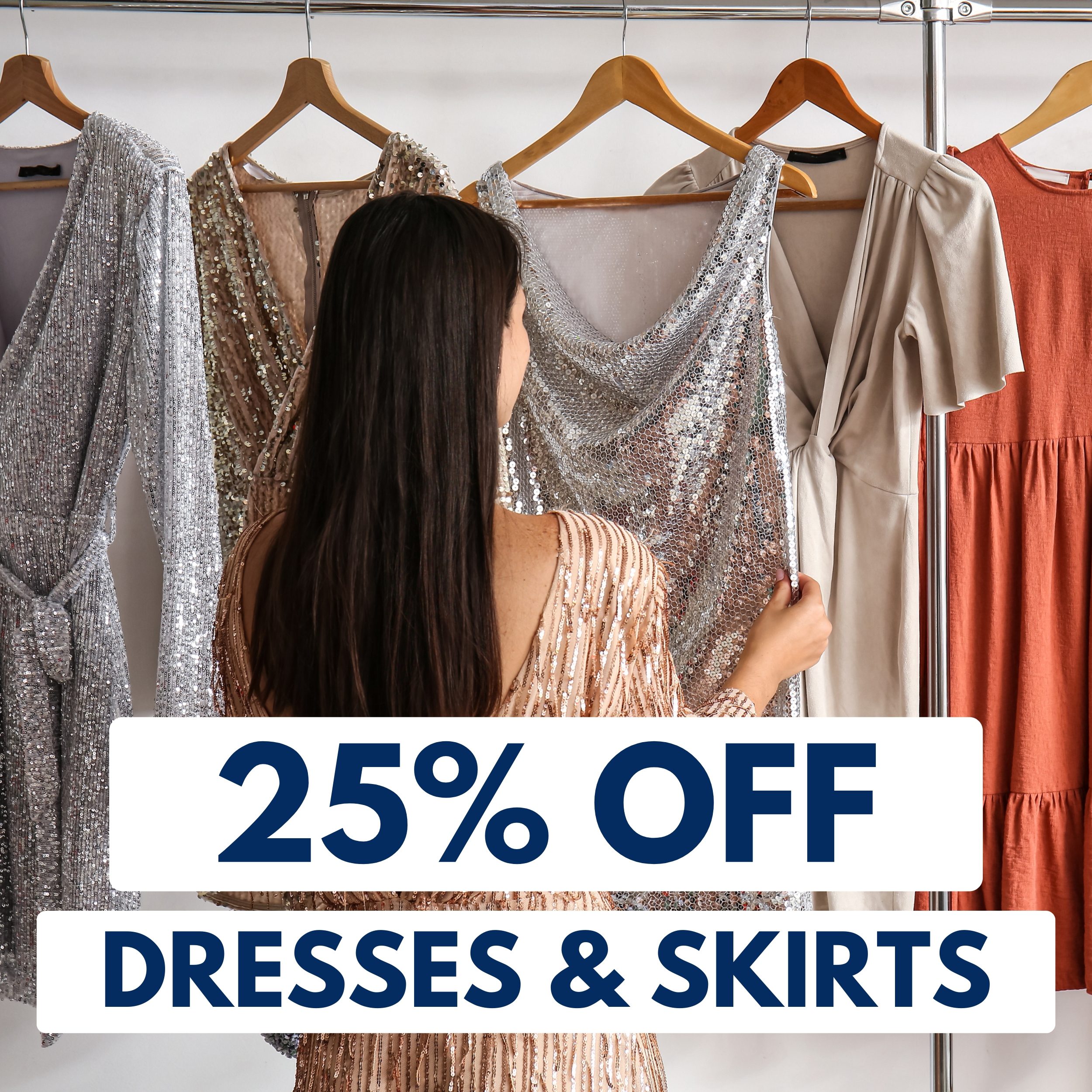 A woman in a sparkly dress looks at dresses on hangers, with a sign in front reading "25% OFF DRESSES & SKIRTS.