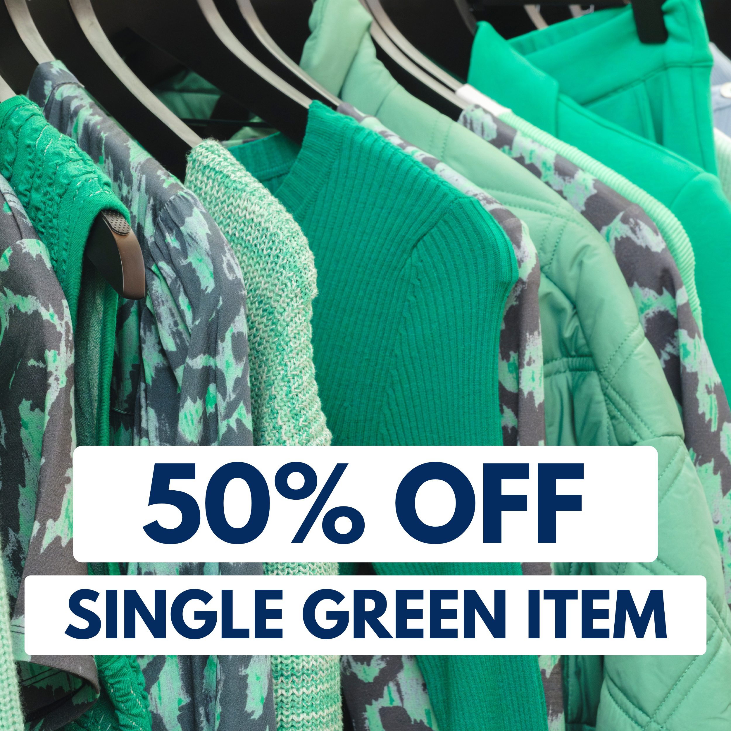 A rack of green clothing with a sign that reads "50% OFF SINGLE GREEN ITEM.