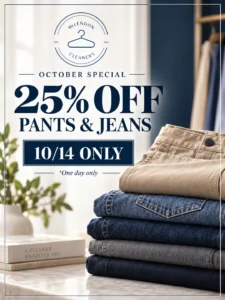 Stack of folded pants and jeans next to a sign reading “25% off pants & jeans, 10/14 only” for an October special at McLendon Cleaners.
